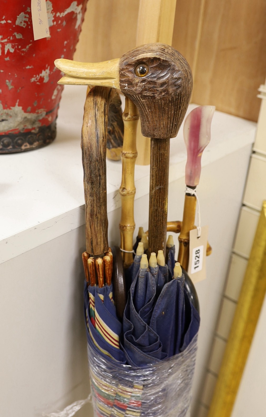 A novelty duck handled umbrella and four others